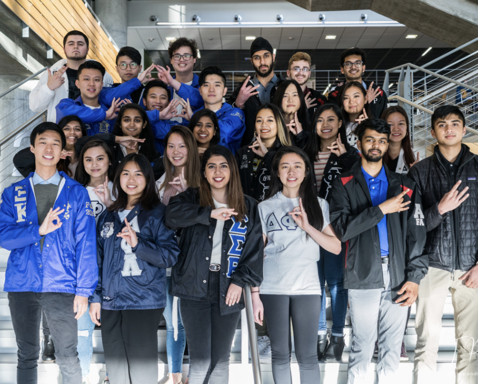 A group of MPC students holding up their hand signs. 